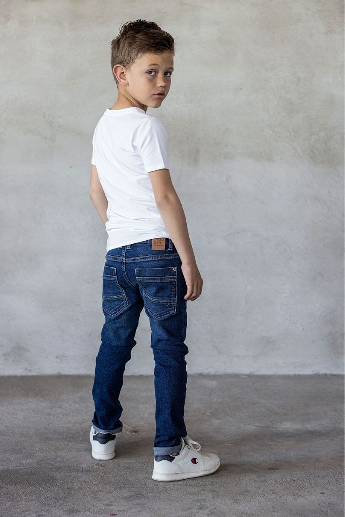 Back view of the boy wearing the skinny jeans in dark wash by TYGO & vito