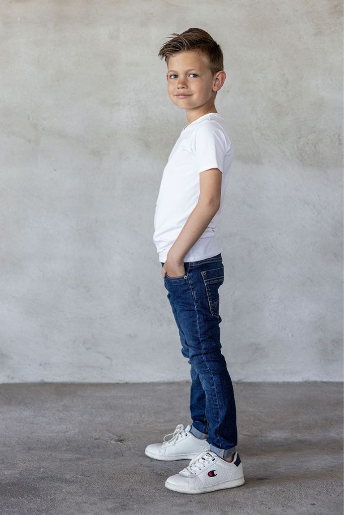 Side view of the boy wearing the dark used wash skinny jeans by TYGO & vito