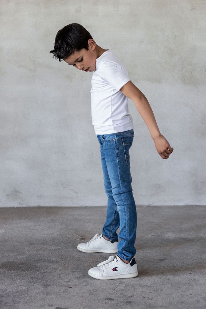 Boy wearing skinny jeans in light used | Side View