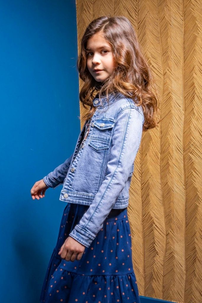 Girl looking in the camera wearing the blue denim jacket by B.Nosy