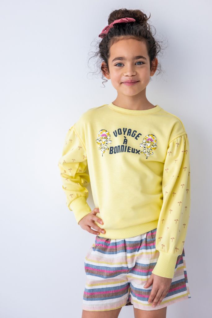 Girl wearing the linen stripe shorts with a yellow jumper