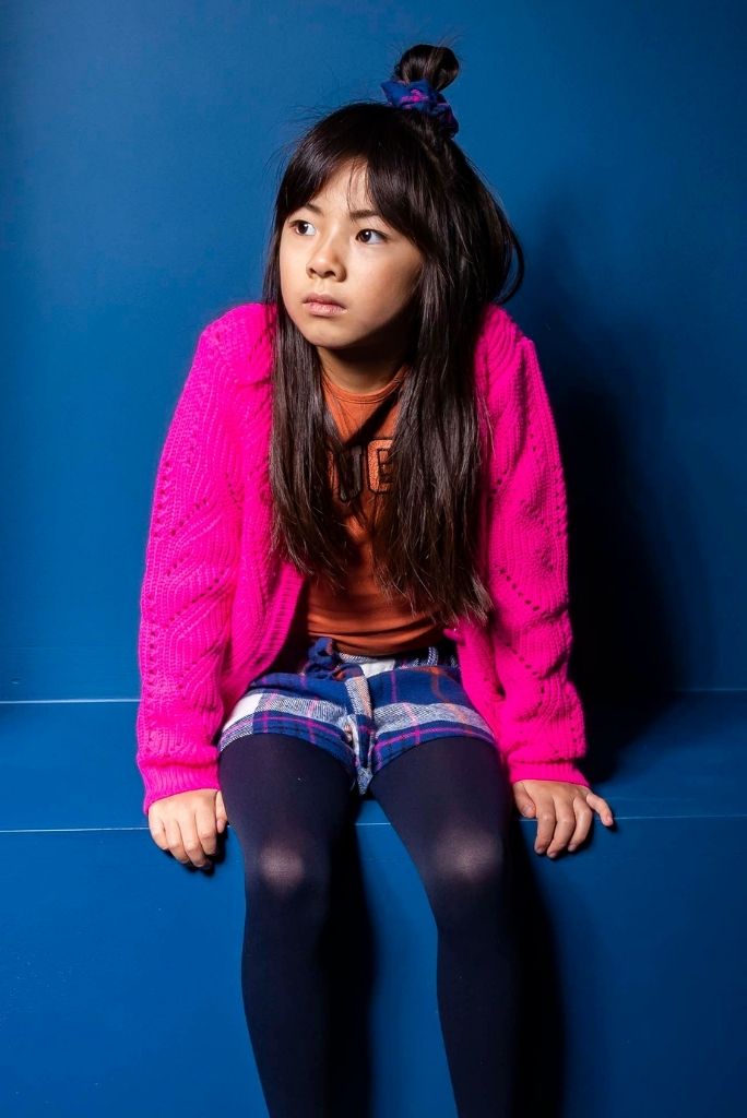 Girl wearing the pink knit cardigan by B.nosy