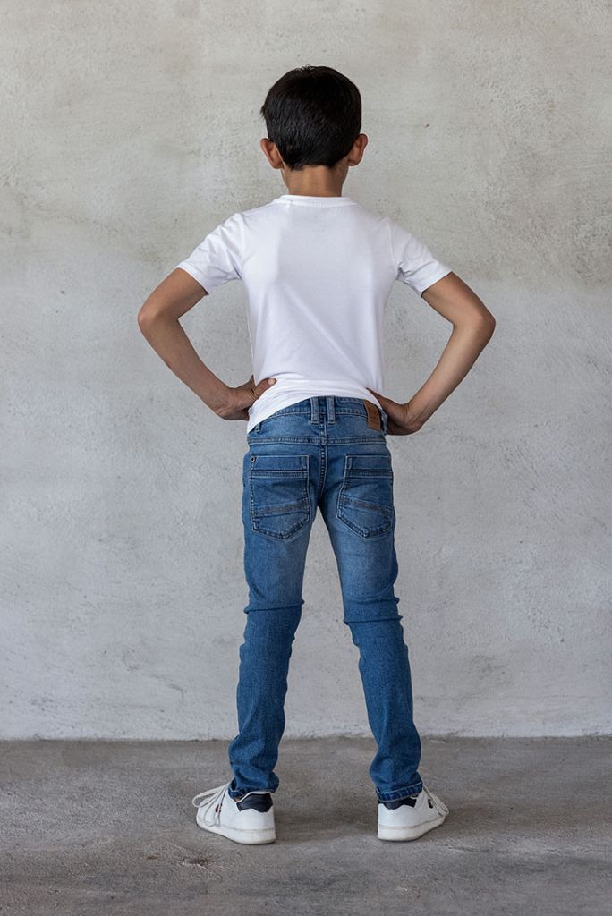Boy wearing skinny jeans in light used | Back View