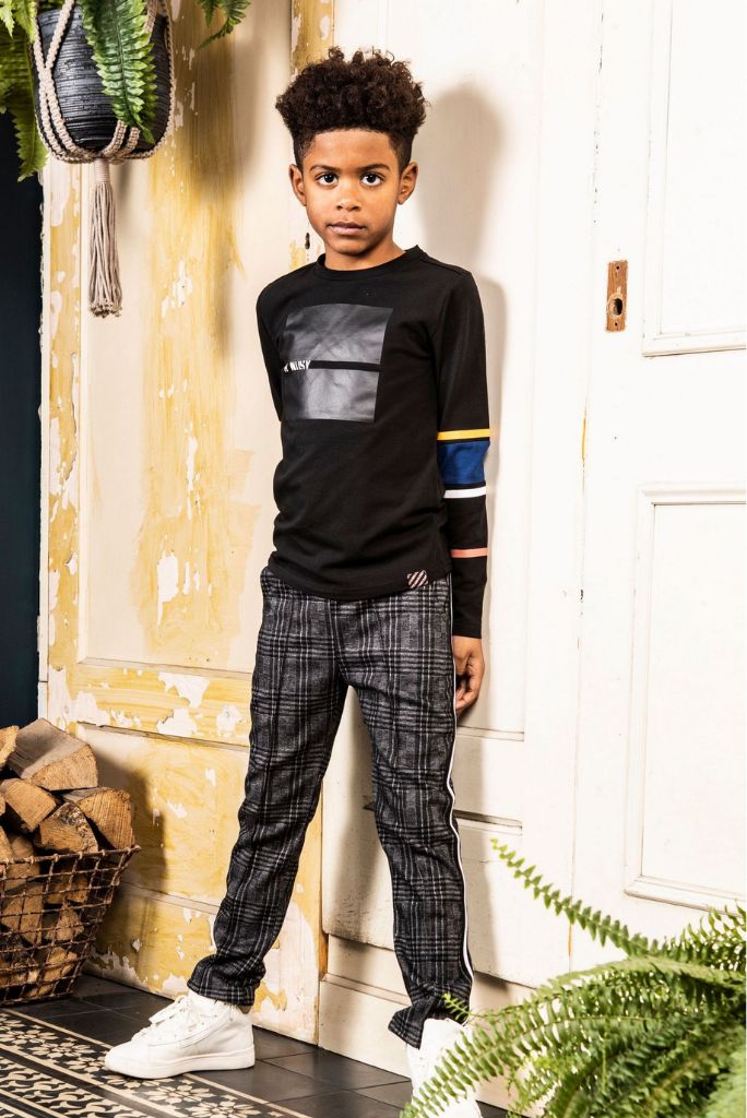 Full length of the boy wearing the black long sleeve top with stripes by B.Nosy