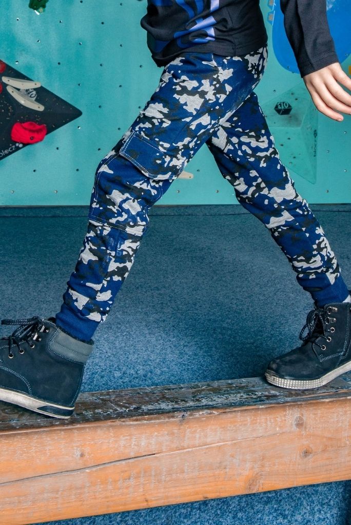 Close view of the boy wearing the camo slim track pants