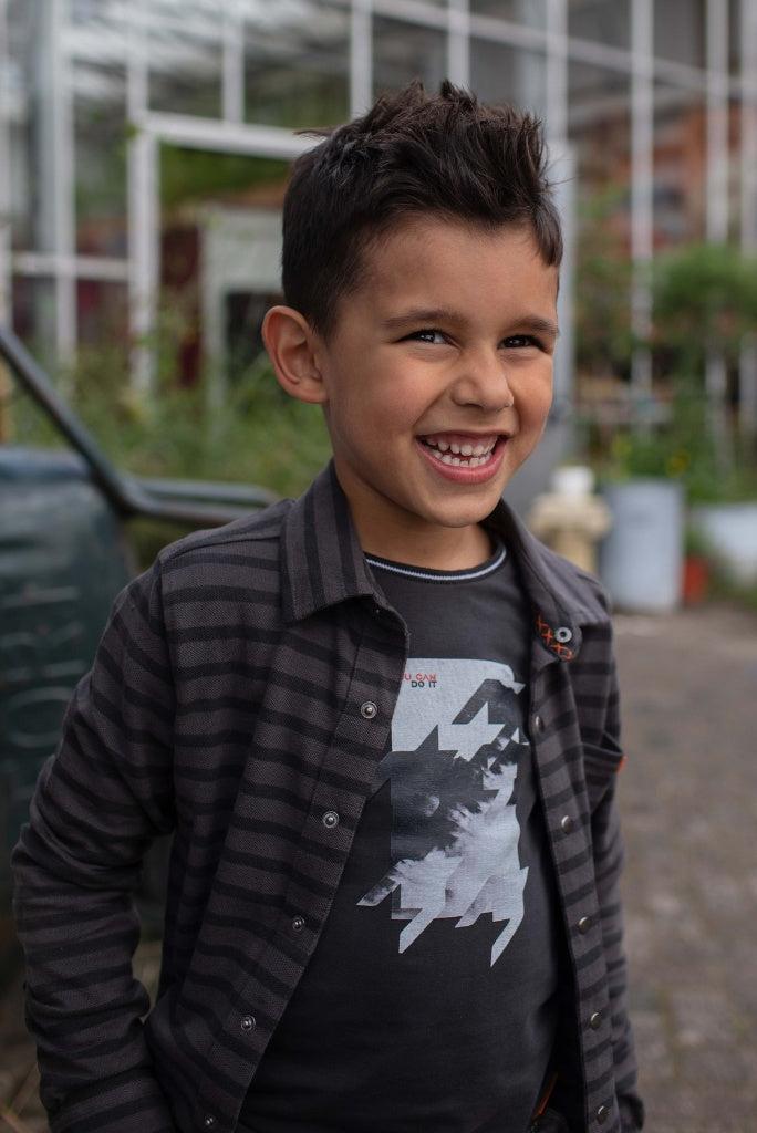 Close view of the smiling boy wearing the grey long sleeve top Kaizer by Quapi