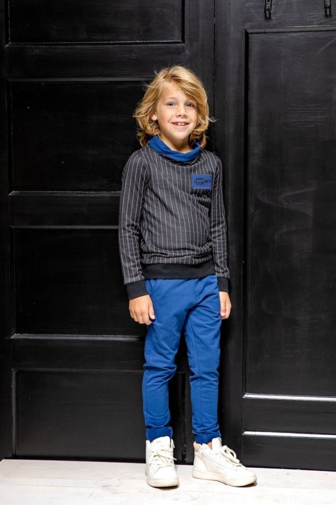 Boy wearing the navy trackpants with a jumper