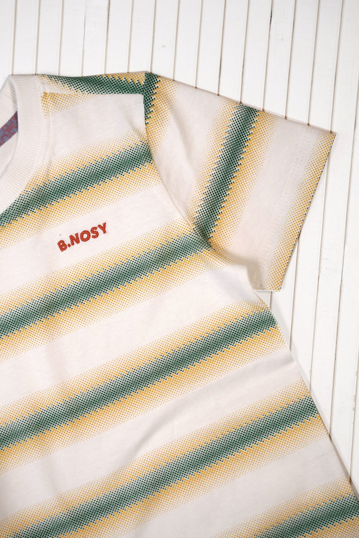 A close-up of a short-sleeve t-shirt with horizontal stripes in green and yellow on an off-white base, featuring the red embroidered text &