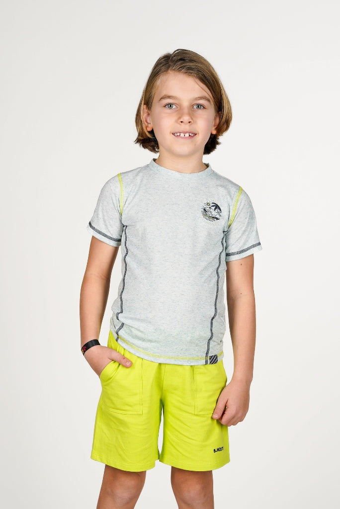 Boy wearing a grey shirt Tony by B.Nosy and yellow shorts on a white background