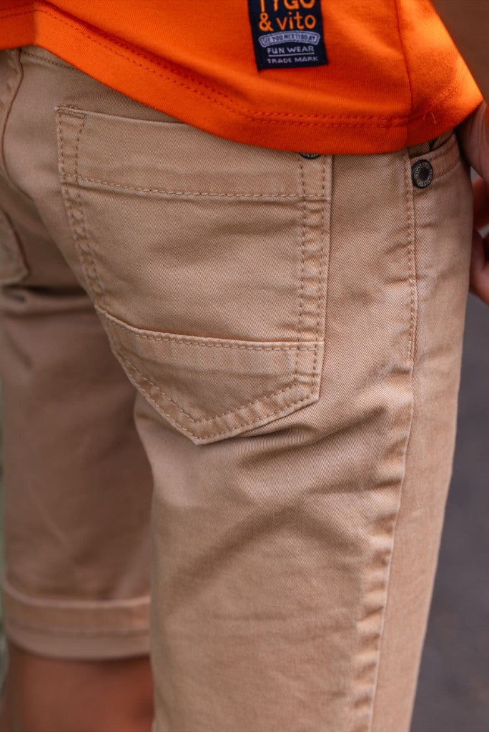 Boys beige shorts Quinn with an orange shirt and visible brand logo.