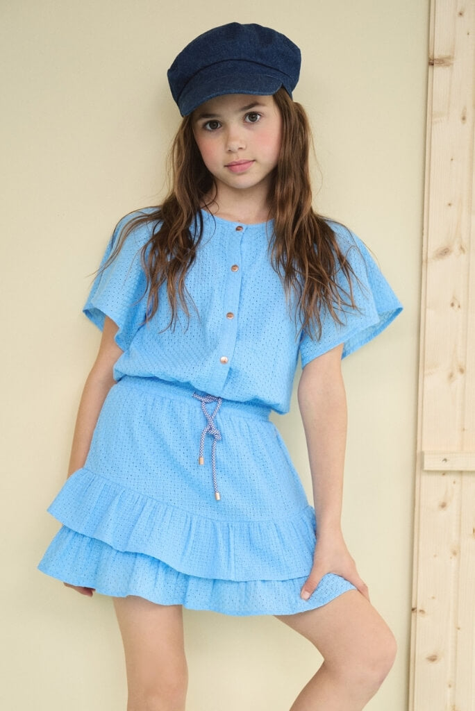 Girl wearing the embroidered dress Siggy by NONO