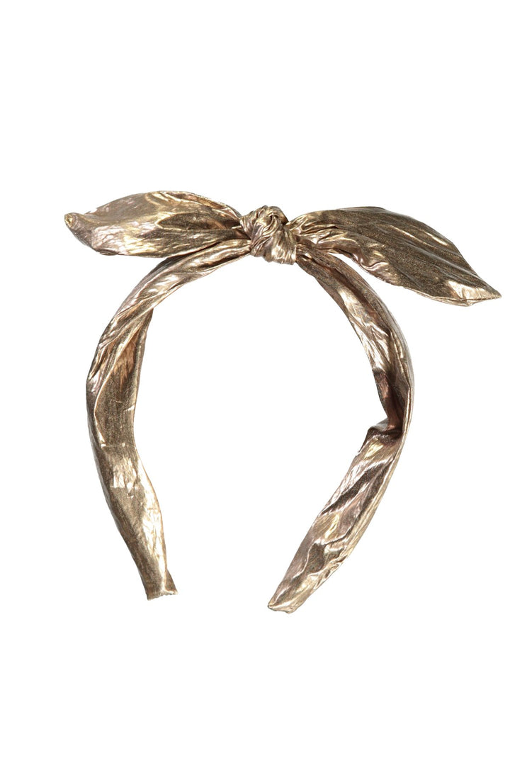 A metallic gold twisted ribbon headband tied in a bow at the top.