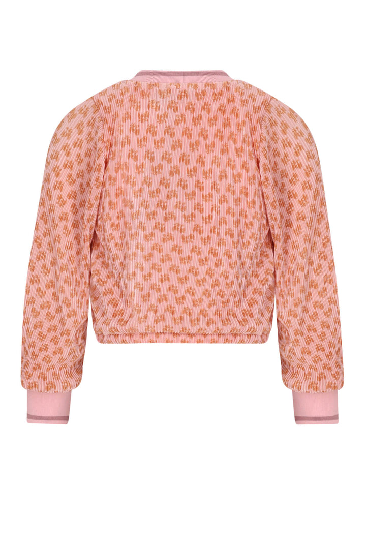 A long-sleeve knit blouse with an allover orange-on-pink geometric pattern, featuring solid pink ribbed cuffs and collar, shown from the back on a white background.