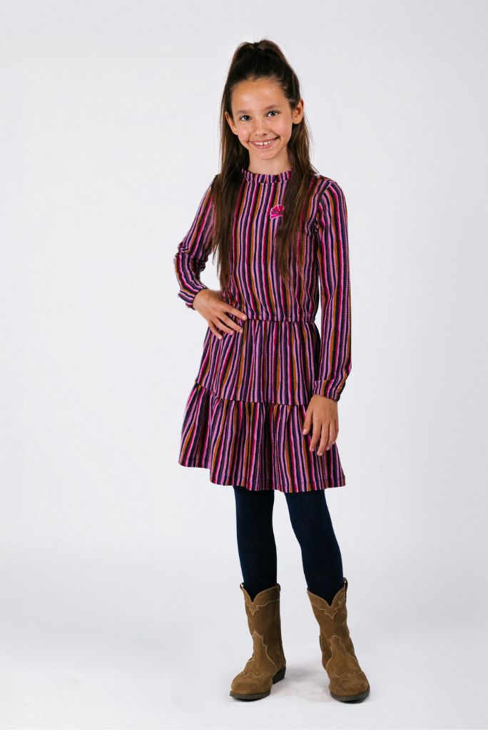 Young girl wearing a striped dress with long sleeves on a white background