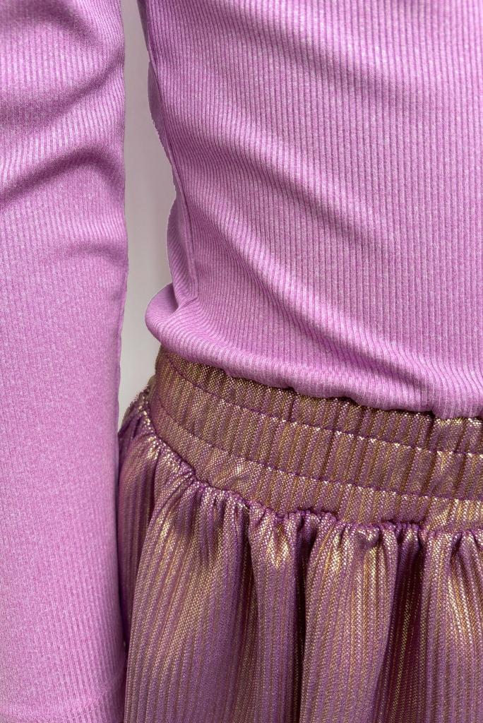 Close-up of a girl wearing the Donia dress by B.Nosy