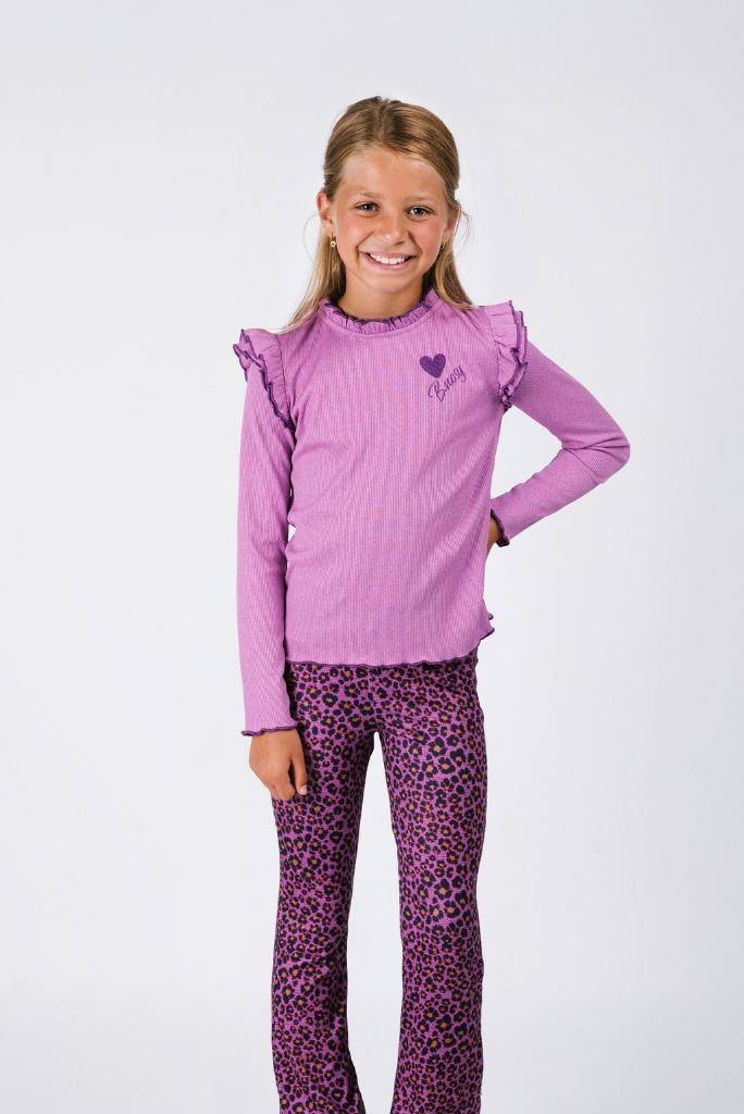 Young girl wearing a purple long-sleeve top and leopard print pants on a white background