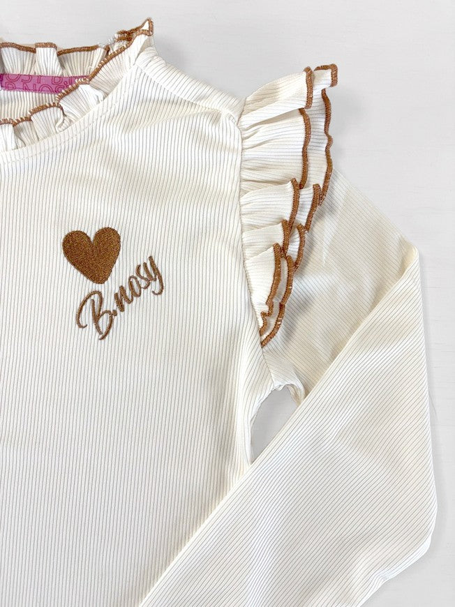 Close view of the shoulder of the white long sleeve top Tonya