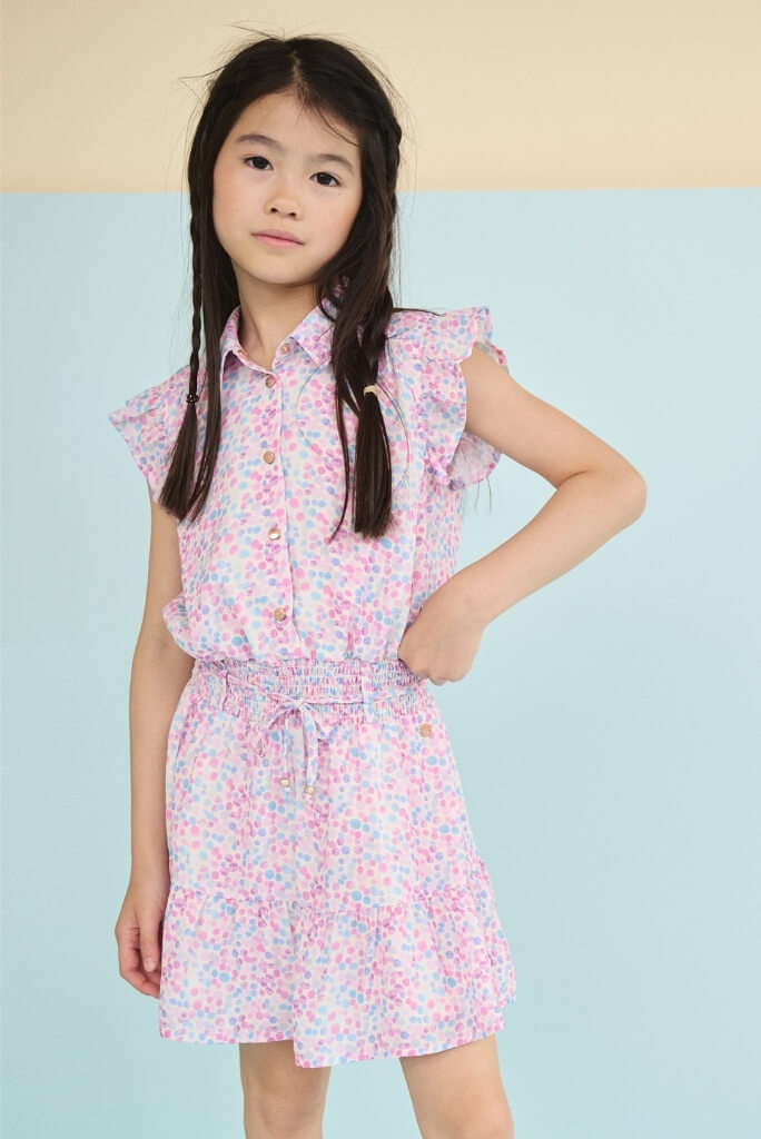 Girl in the Minou dress by NONO looking directly in the camera.