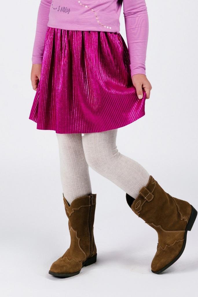 Girl wearing a pink pleated skirt, pink long-sleeve top, white tights, and brown boots on a white background