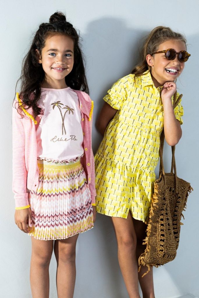 Two girls standing and laughing in Like FLO clothing