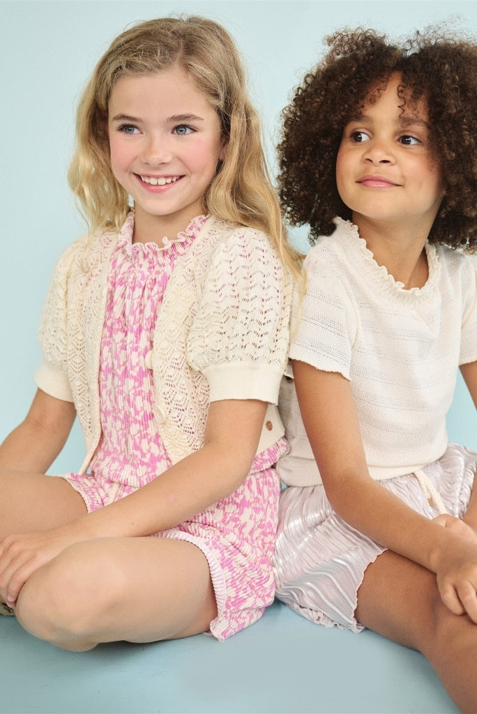 Two girls sitting wearing playsuits by NONO