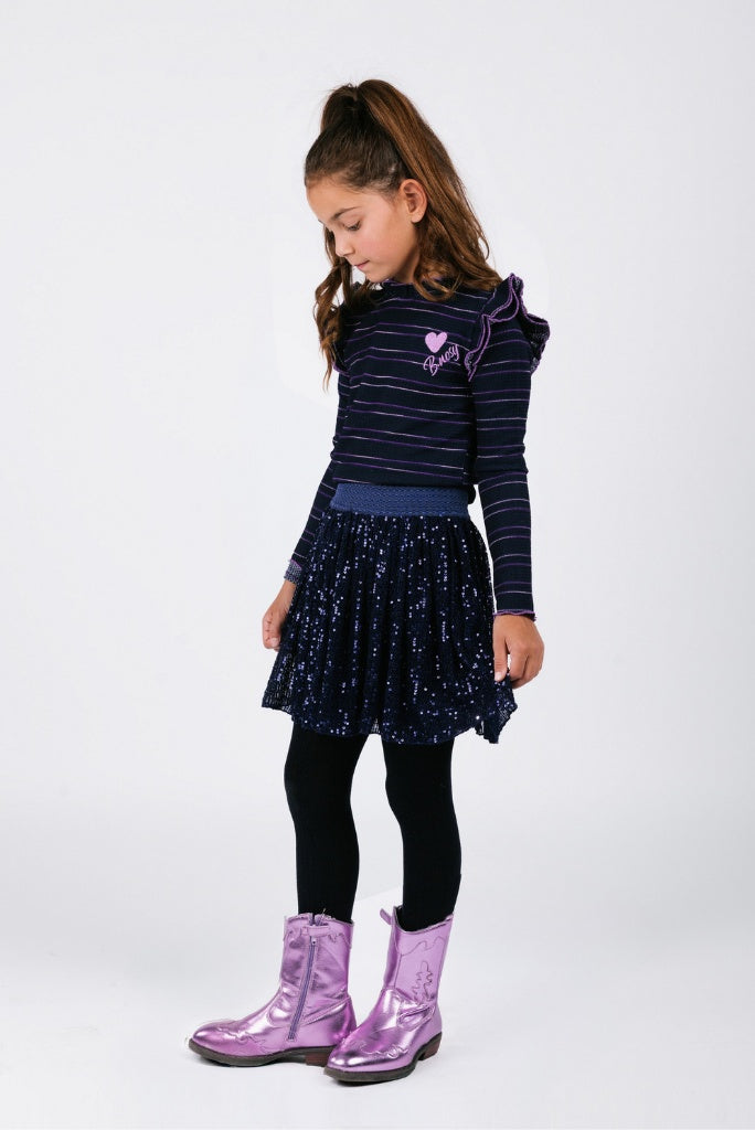 Young girl in a striped top and navy sequin skirt.