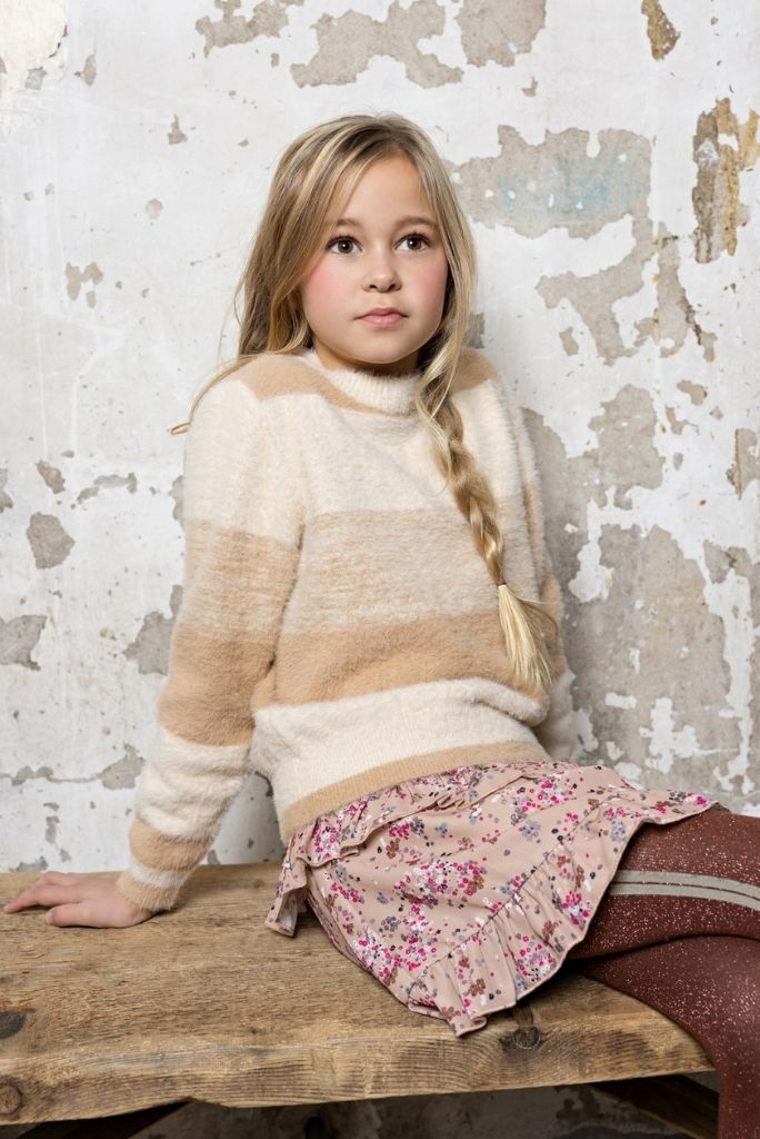 Girl wearing the Neva skirt with a sweater 