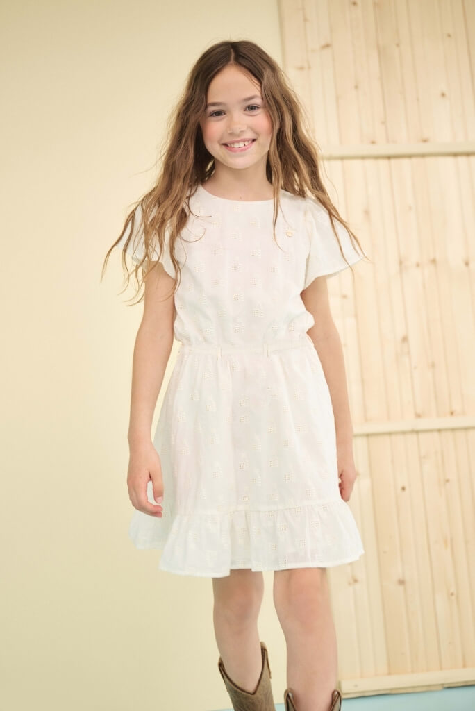 Smiling girl wearing the white dress Mirabel by NONO
