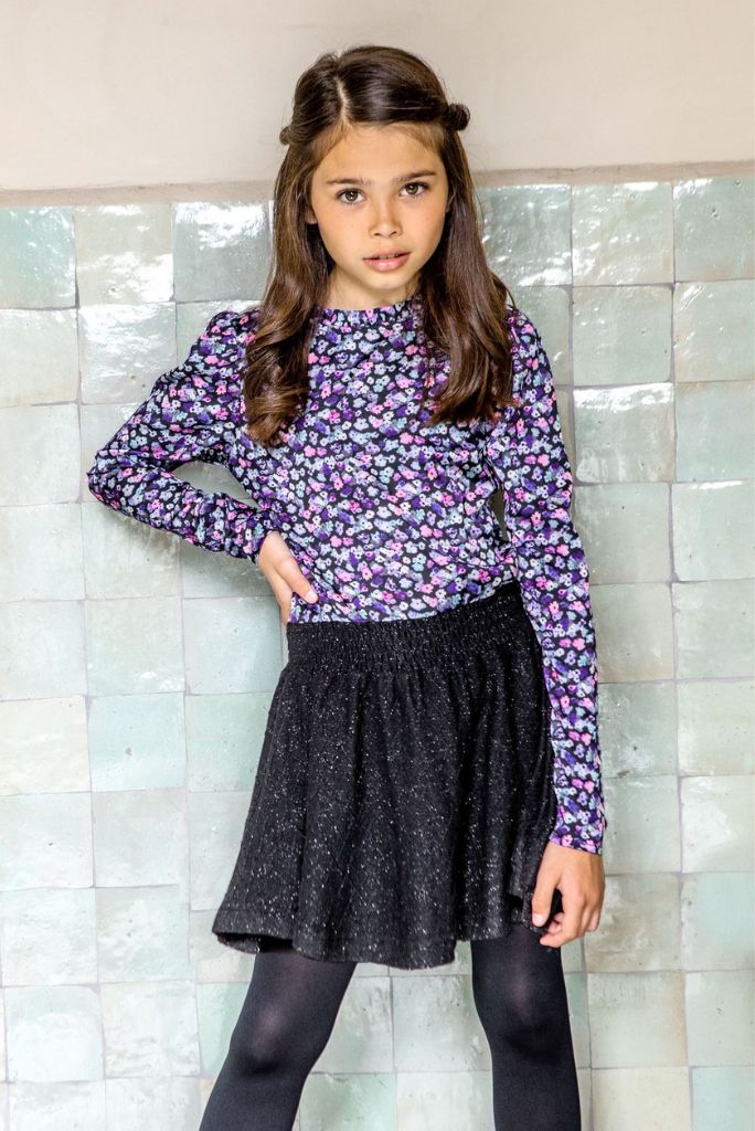 Teen girl wearing the floral long sleeve party dress with glitter skirt