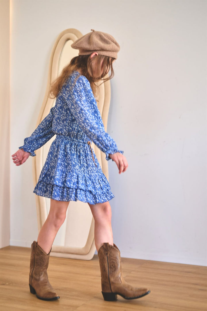 a girl looking on the floor wearing the blue dress Miggy by NONO