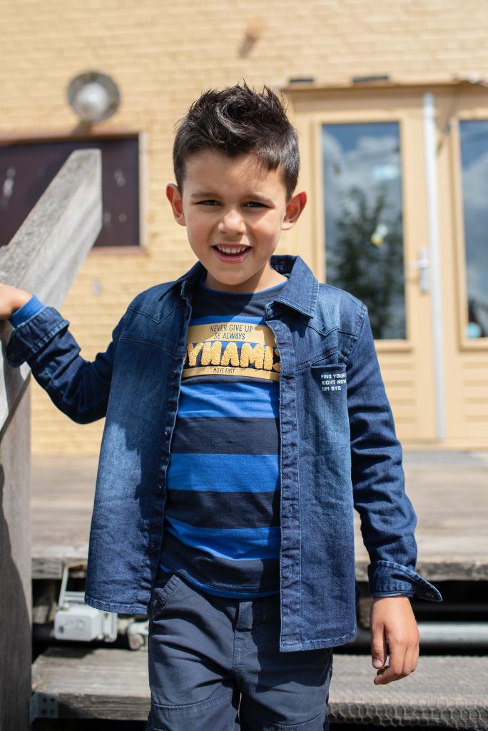 Close view of the boy wearing the long sleeve top Karas with a denim shirt