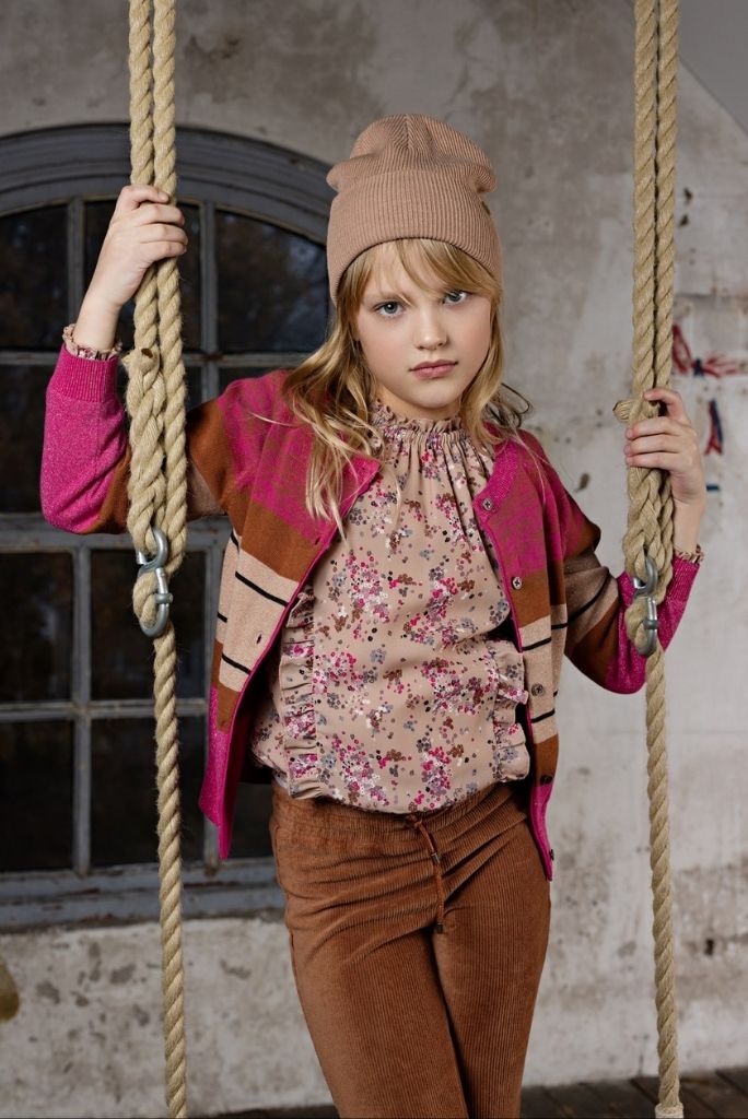 Girl wearing the floral blouse Tina and looking in the camera