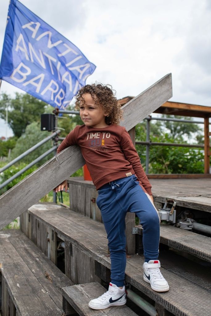 Boy wearing the navy track pants by Quapi